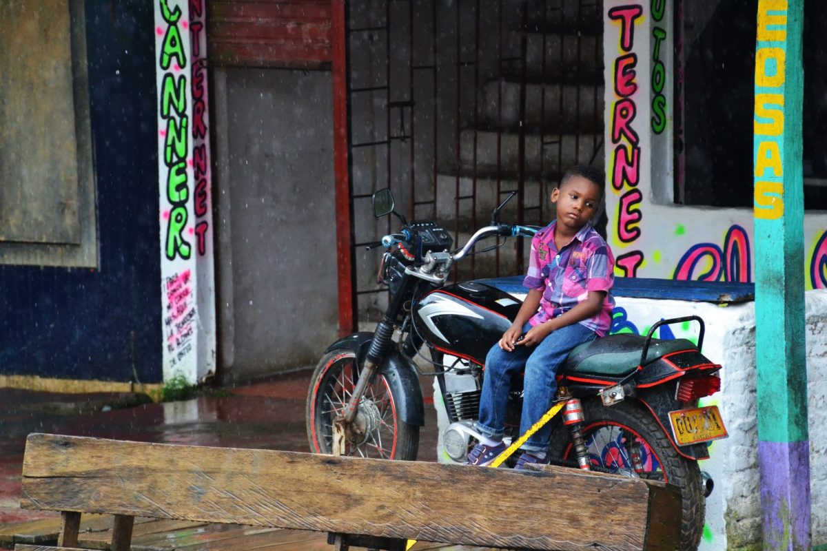 Young kid sitting on a motorcycle in San Cipriano Colombia