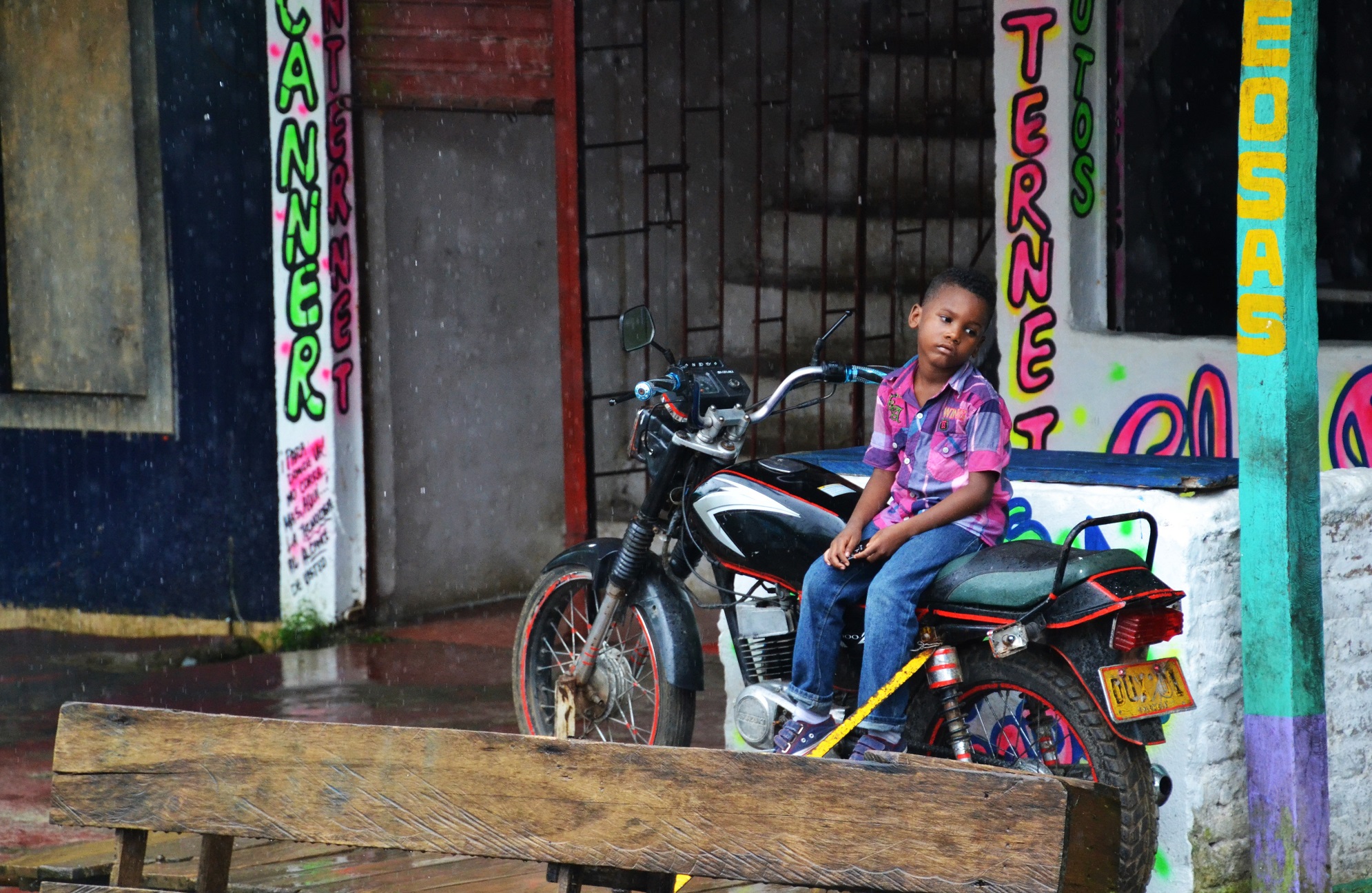 Young kid sitting on a motorcycle in San Cipriano Colombia